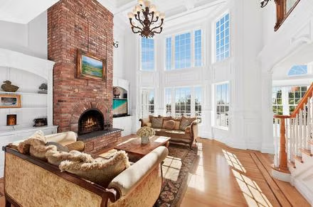Elegant living hall with cozy fireplace, showcasing Hamptons style decor and coastal-inspired design.